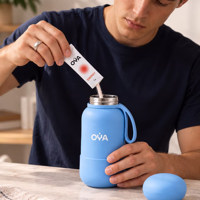 A man pouring an OYA ENERGY stick into the bottle